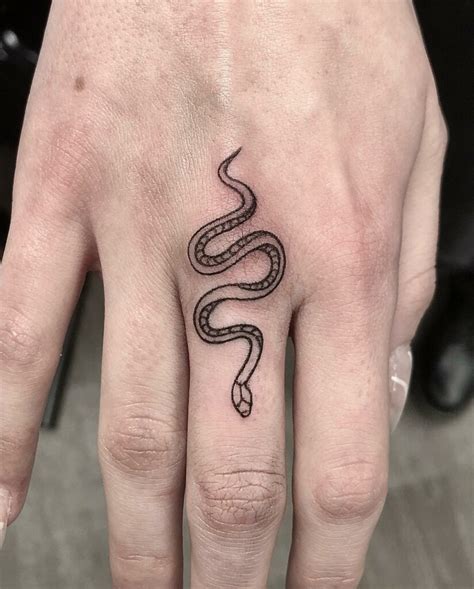 snake on finger tattoo meaning.